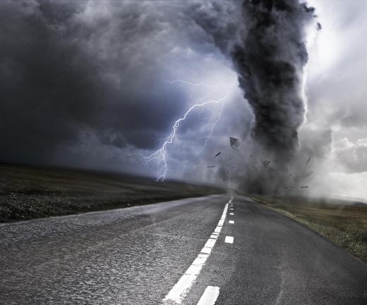If a driver spots a tornado, he or she immediately should pull over and find a ditch to lie down in.